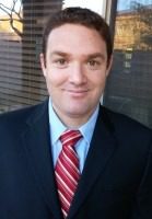 Man in suit with red striped tie.